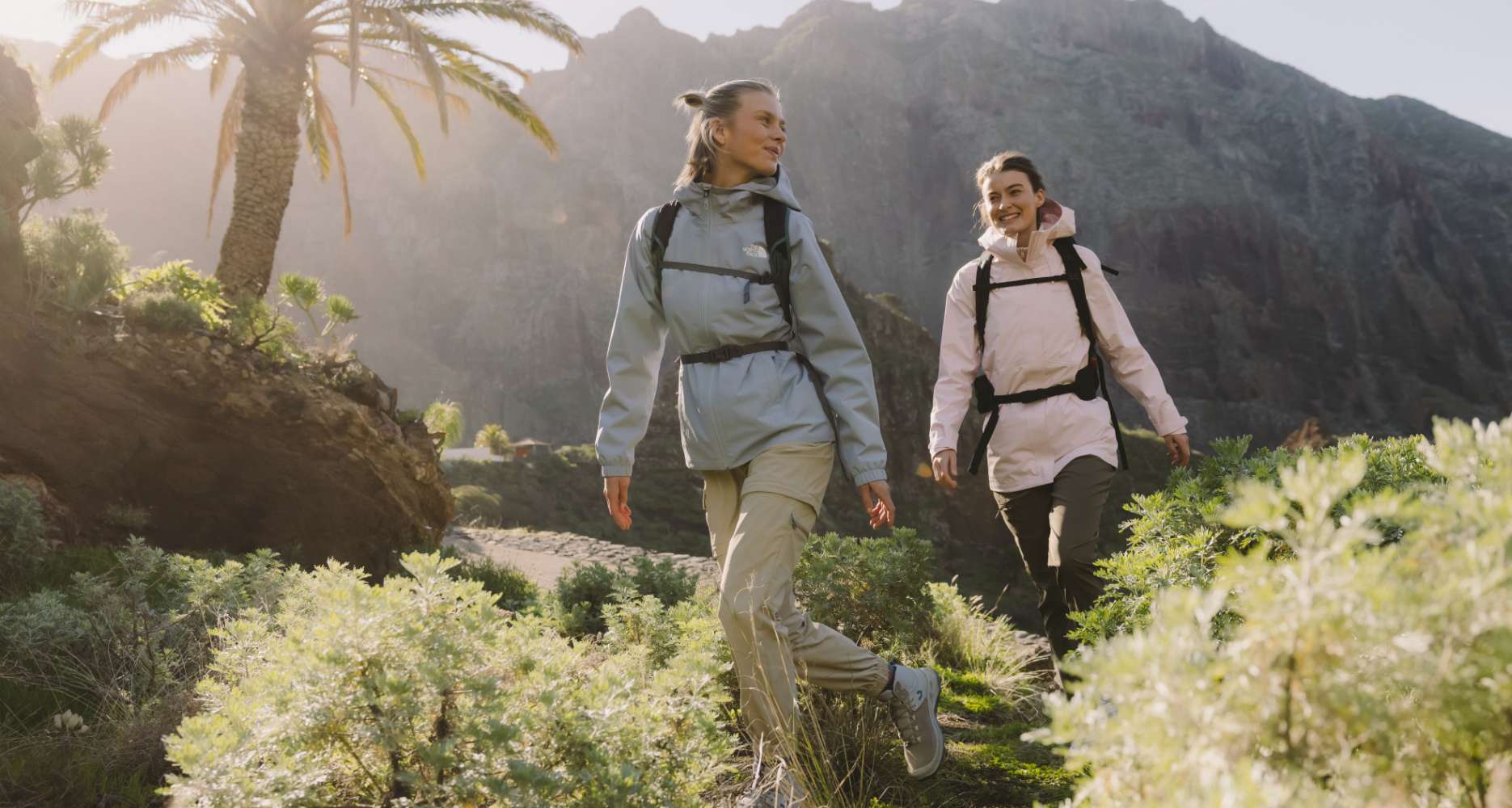 Man hiking with walking poles and backpack