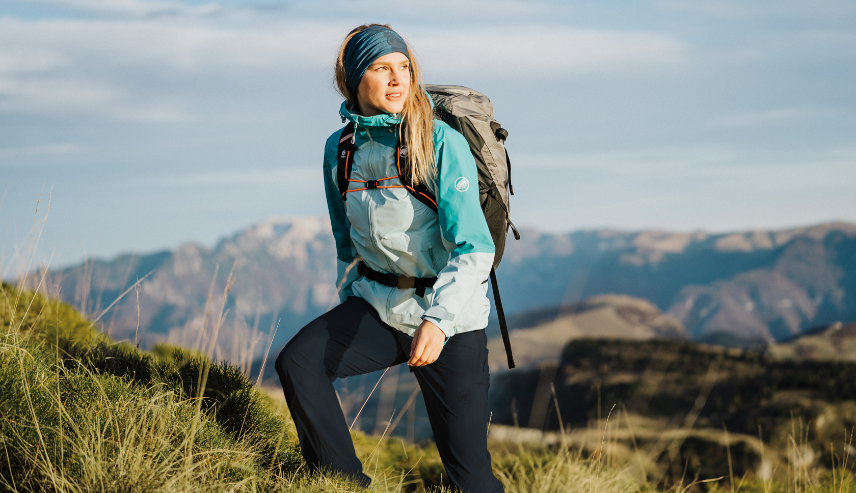 Man hiking with walking poles and backpack