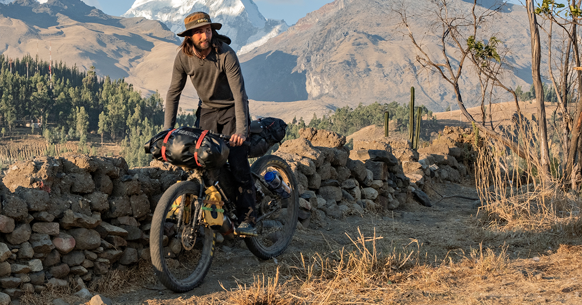 Man relaxing near his tent and bike