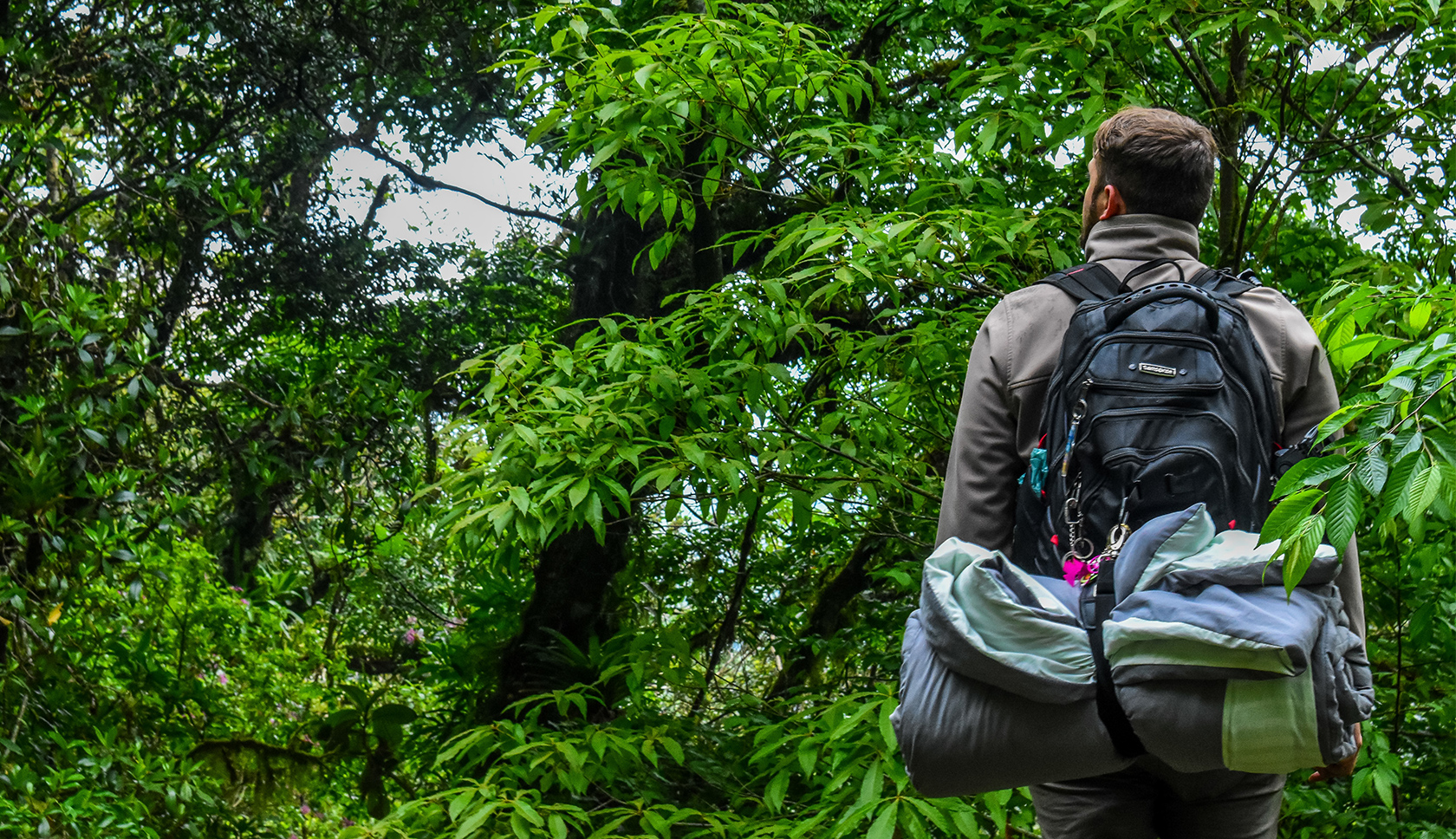 woman hiking wearing a blue rucksack