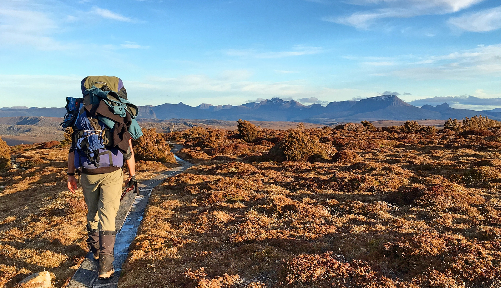 woman hiking wearing a blue rucksack