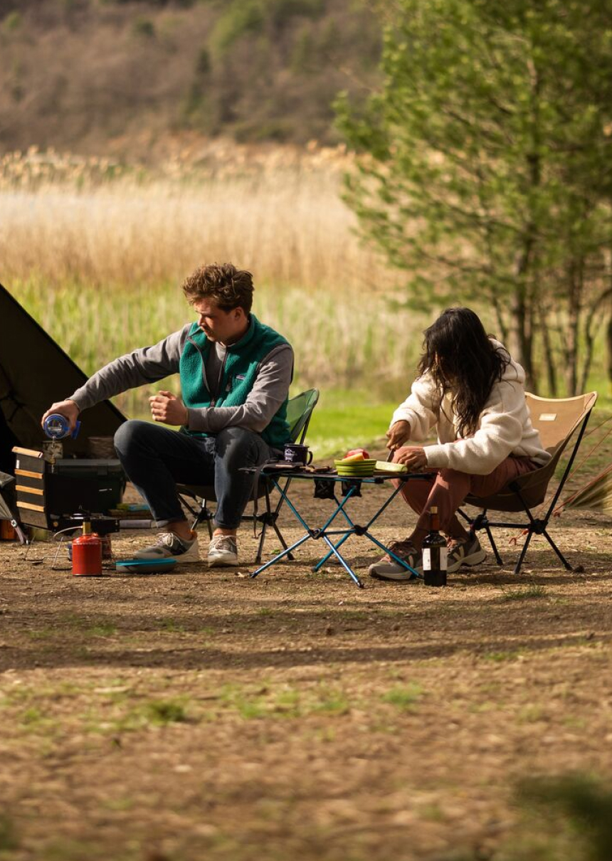 Couple enjoying breakfast in the morning near their tent