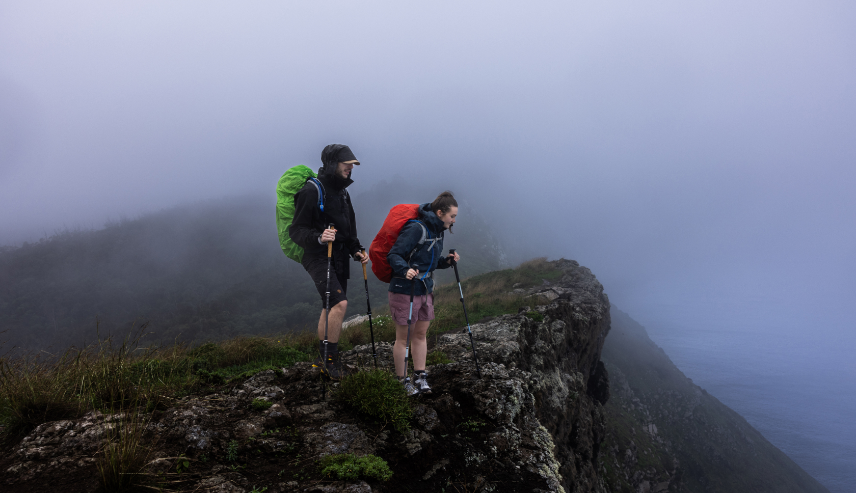 Two hikers under the rain