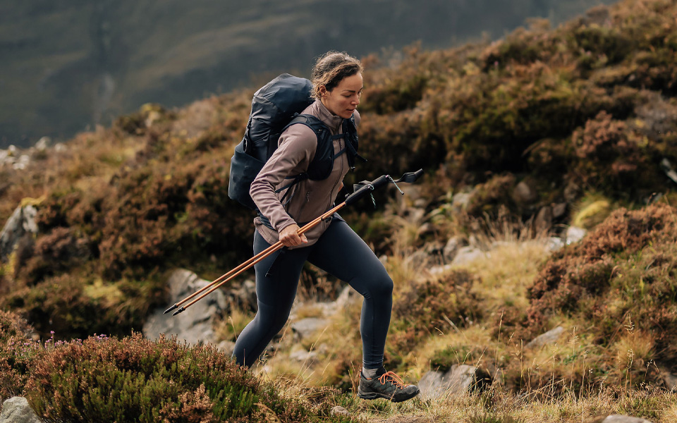 A woman wearing a Mountain Equipment jacket and helmet climbing