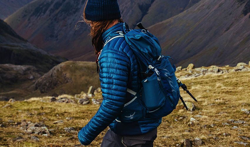 woman hiking wearing a blue rucksack