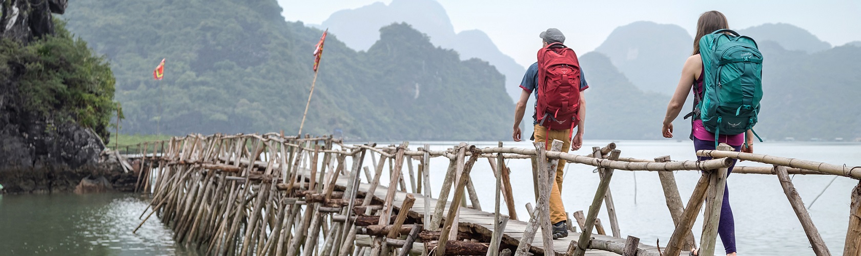 Walkers crossing a wooden bridge