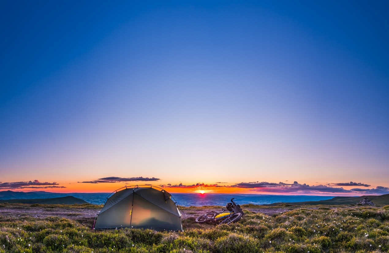 A person on a camping trip on a sleeping mat