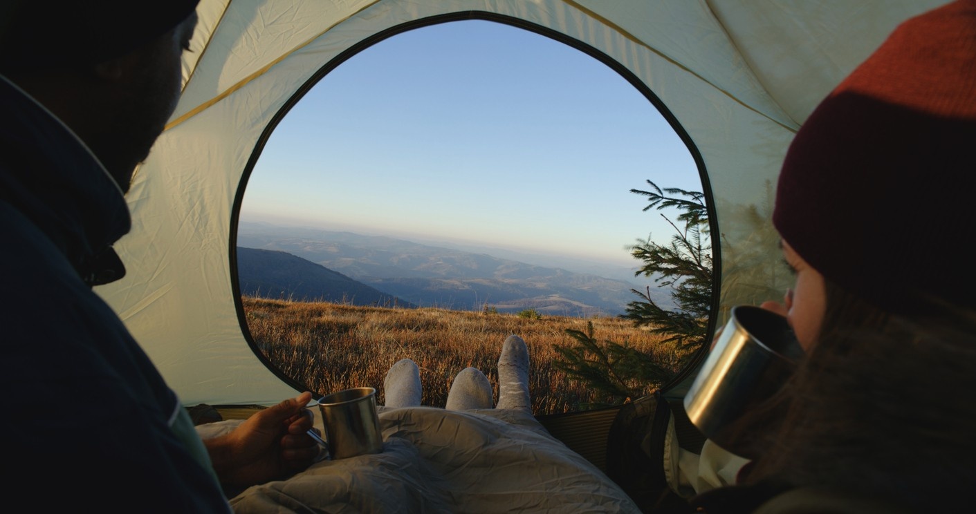 A woman and a man are pitching a tent