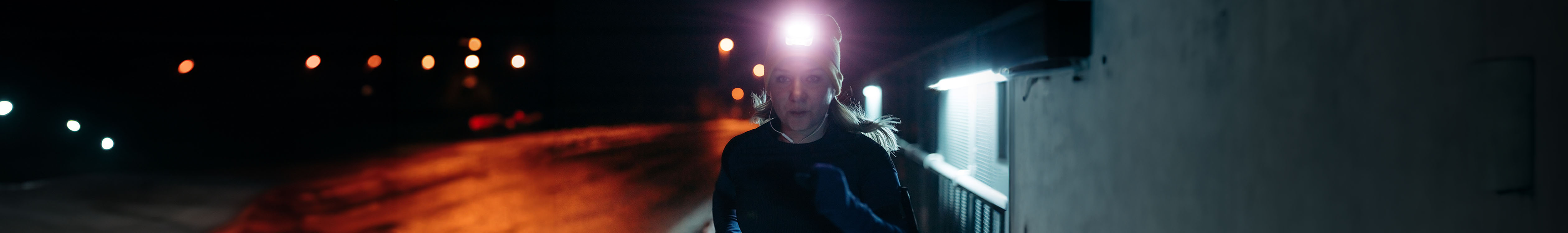 A person wearing a head torch in the dark 