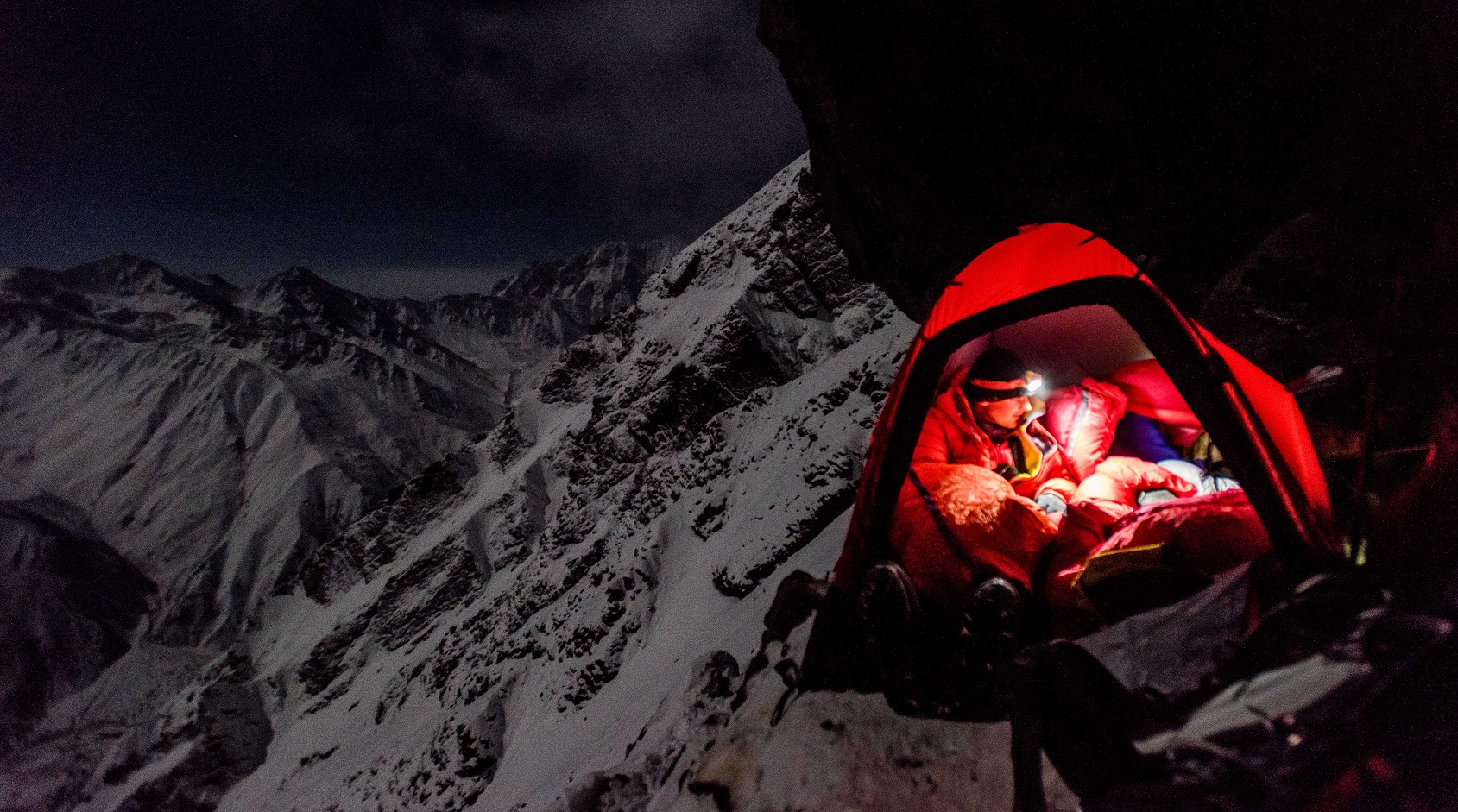 Person in their tent camping in the mountain