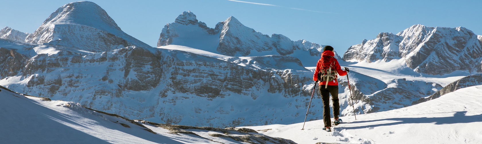 A person wearing a backpack whilst skiing